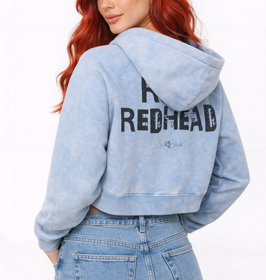 Redhead wears a cropped snow-wash pale Blue hoodie with bold black “RICH REDHEAD” Ed Gein font and the RedBlonde signature logo printed below.