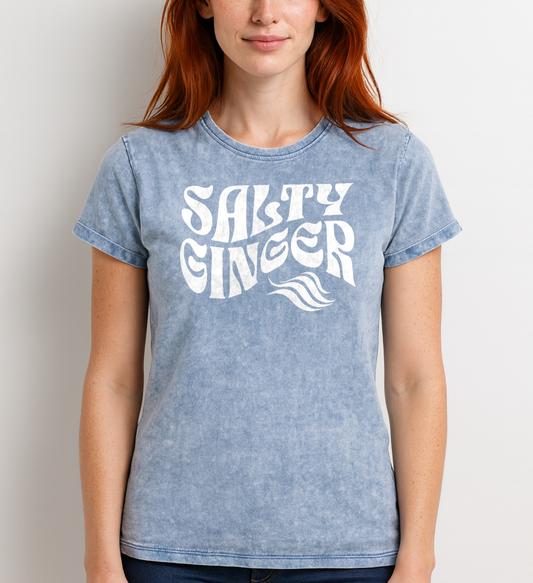Redhead wears a blue vintage wash graphic t-shirt with the slogan 'Salty Ginger' in white retro 70s wavy font. Branded RedBlonde inside neck and right shoulder in red