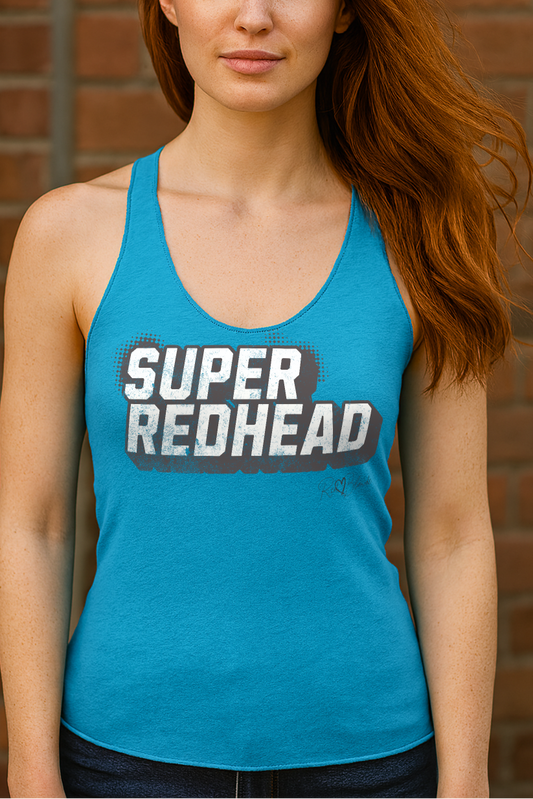redhead wears a Women’s vintage turquoise racerback tank top with bold black “SUPER REDHEAD” in Univercity font block comic-style font with halftone detail, featuring the RedBlonde logo signature beneath the design.