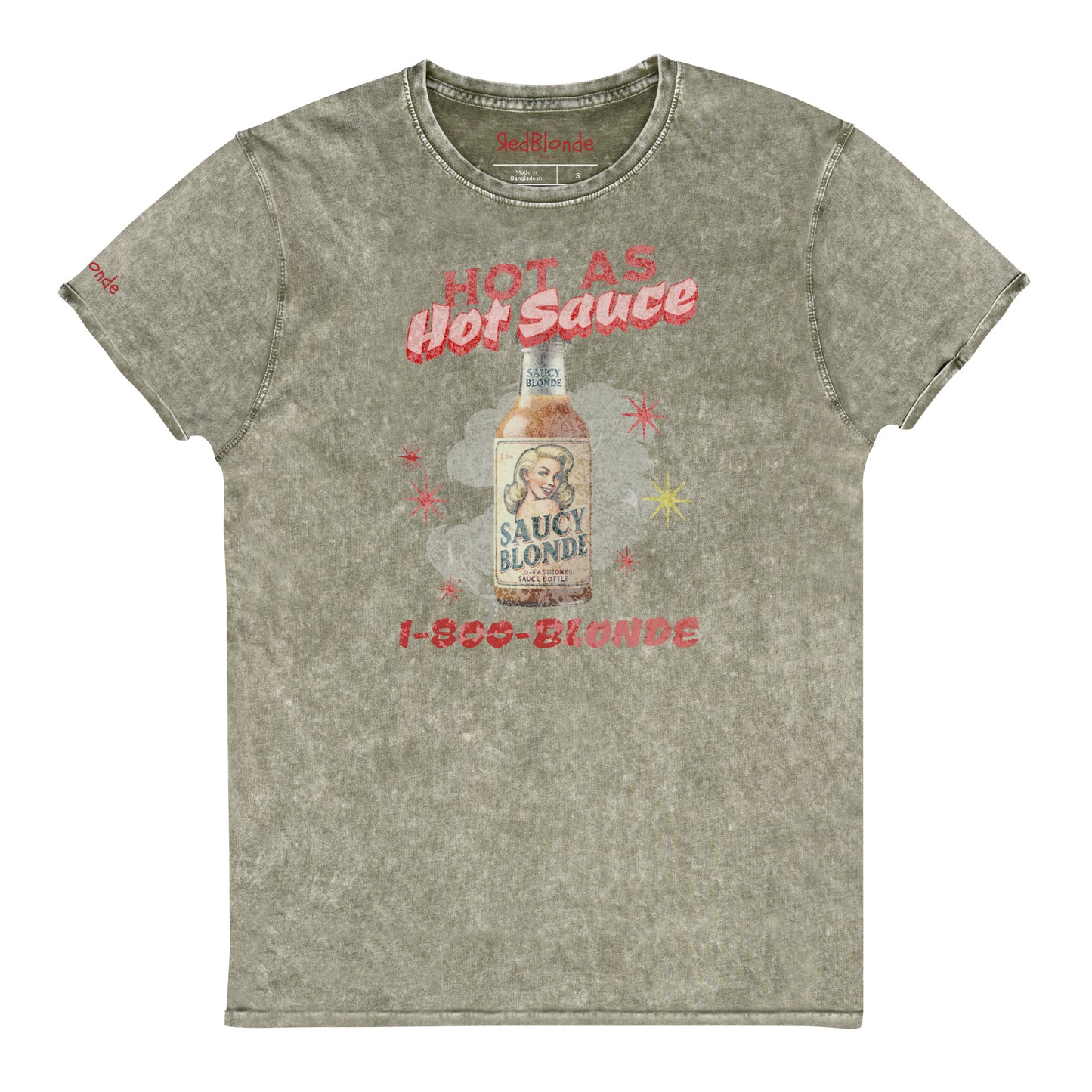 flatlay of a relaxed army green denim-wash t-shirt with a retro American-vintage pop-art graphic featuring a bottle of sauce with Saucy Blonde on it and the words Hot As hot Sauce. branded with redblonde london in red on the inside neck and right shoulder