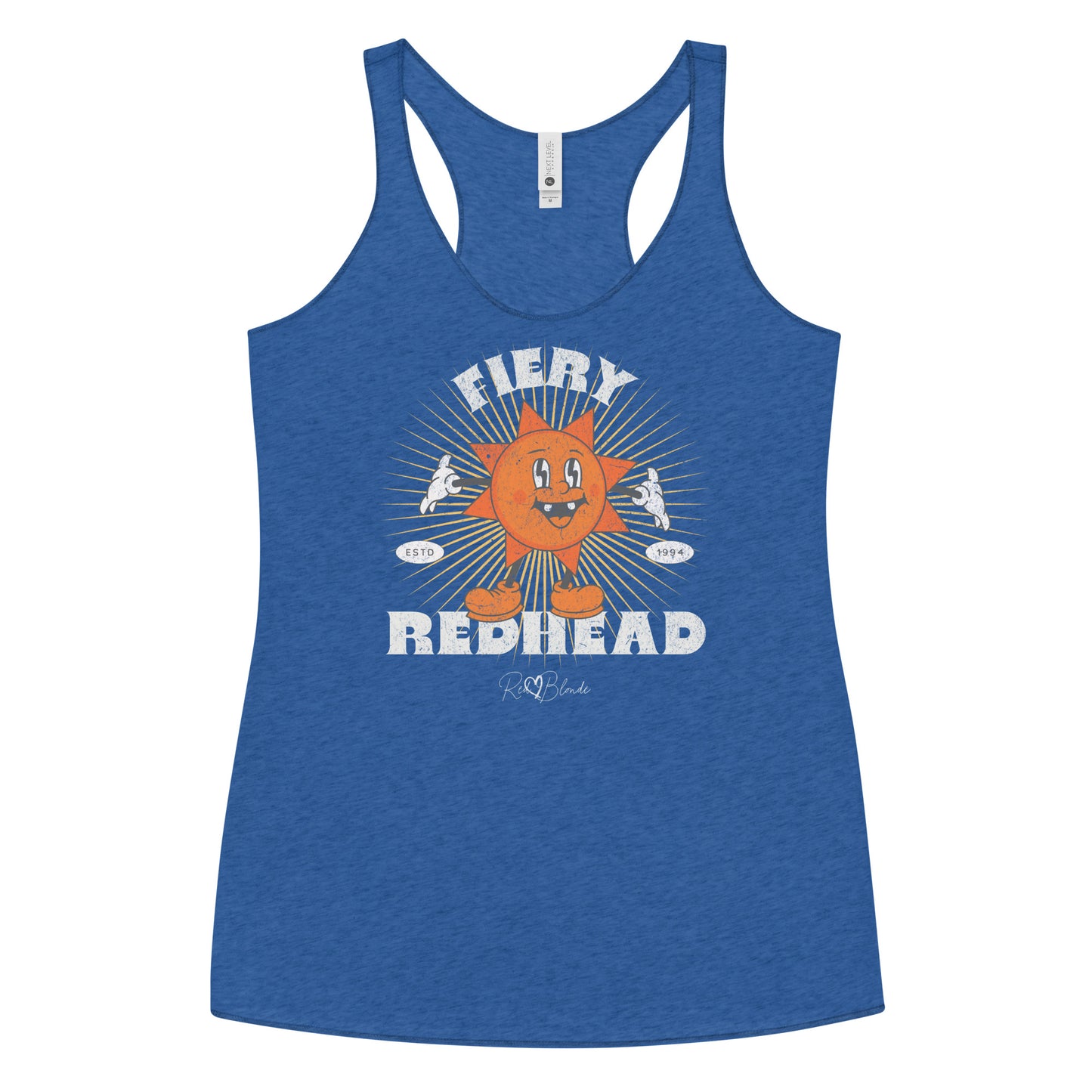 Royal Blue women’s racerback tank with a bold retro graphic of a smiling orange cartoon sun character, surrounded by radiant sunbeams. The text reads ‘Fiery Redhead’ in distressed white Belzebuth lettering with small details including ‘ESTD 1994’ and the RedBlonde signature logo beneath."