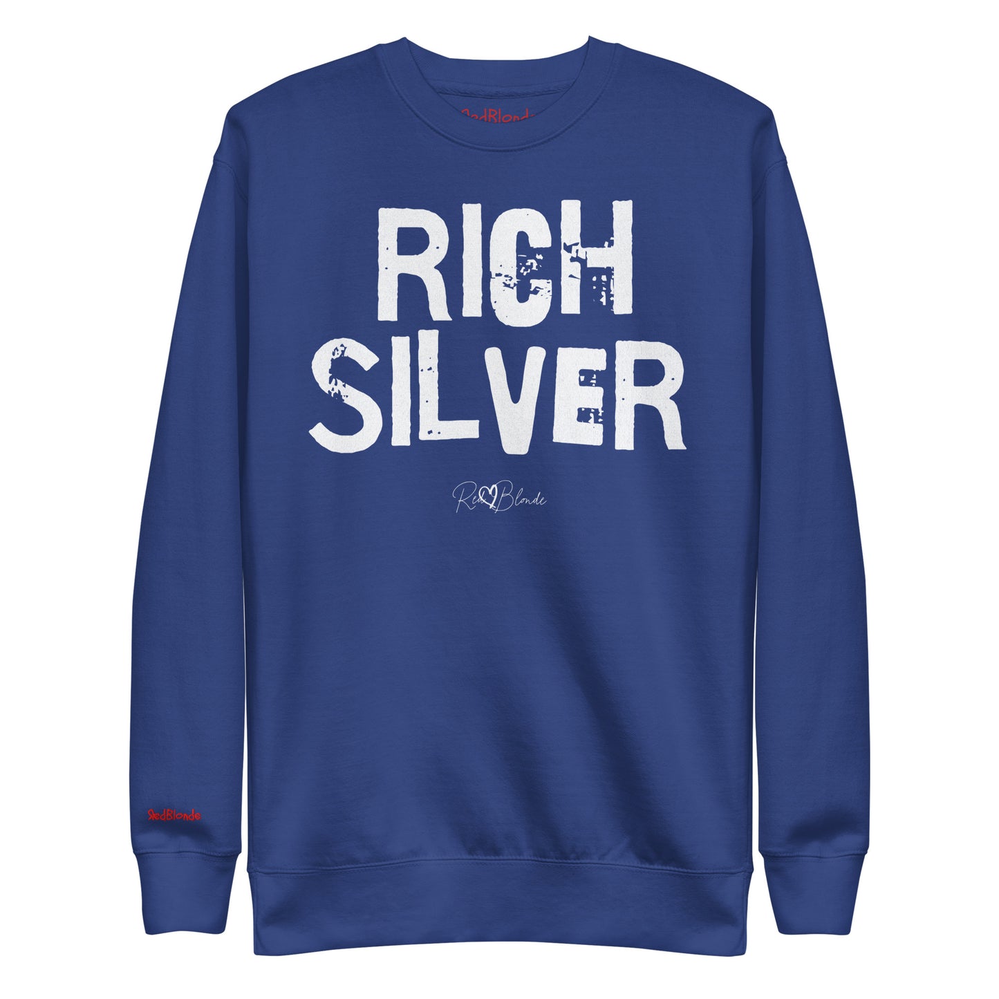 Royal Blue unisex premium sweatshirt with bold distressed white Ed Geinitext “RICH SILVER” on the front, featuring a subtle RedBlonde logo beneath the lettering and on the sleeve cuff and inside neck