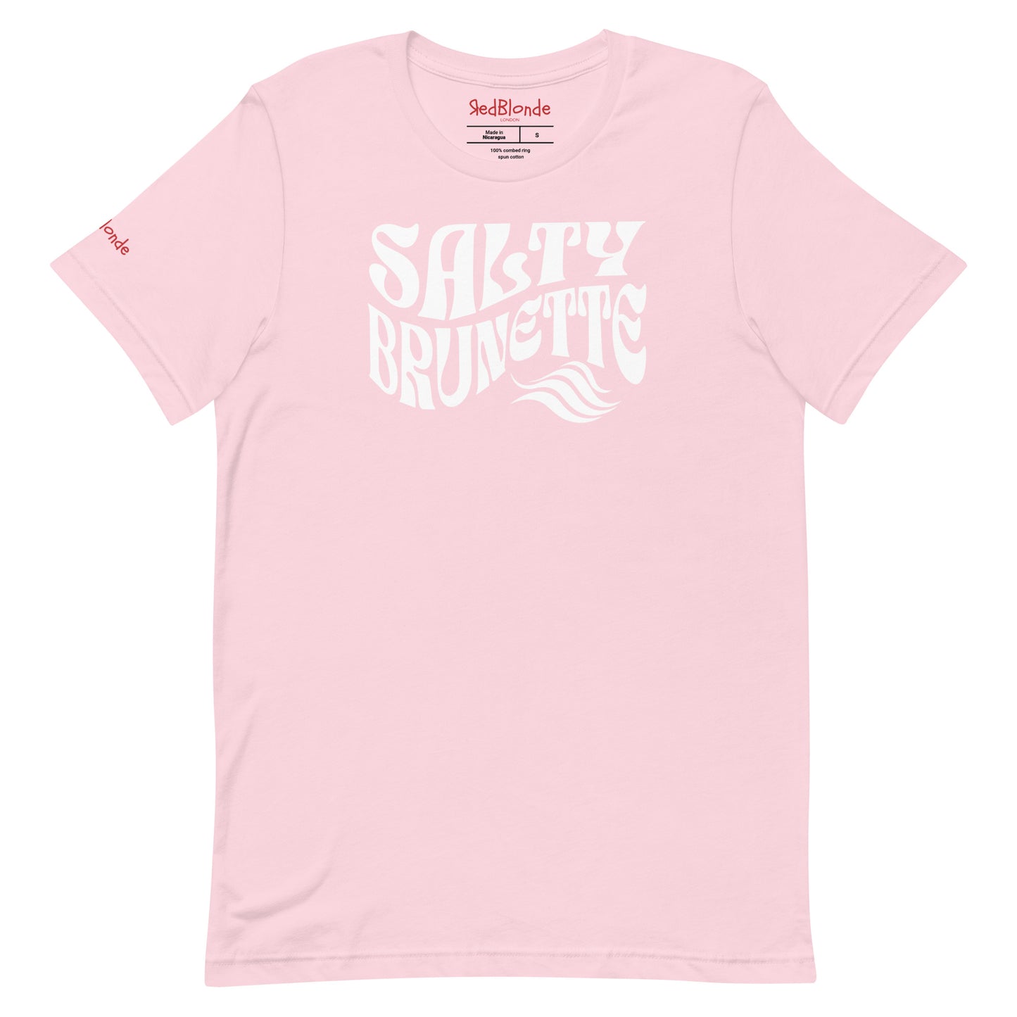 flatlay of soft pink classic unisex graphic t-shirt with the slogan 'Salty Brunette' in Solino Display white retro 70s wavy font. Branded RedBlonde in red on inside neck and right sleeve