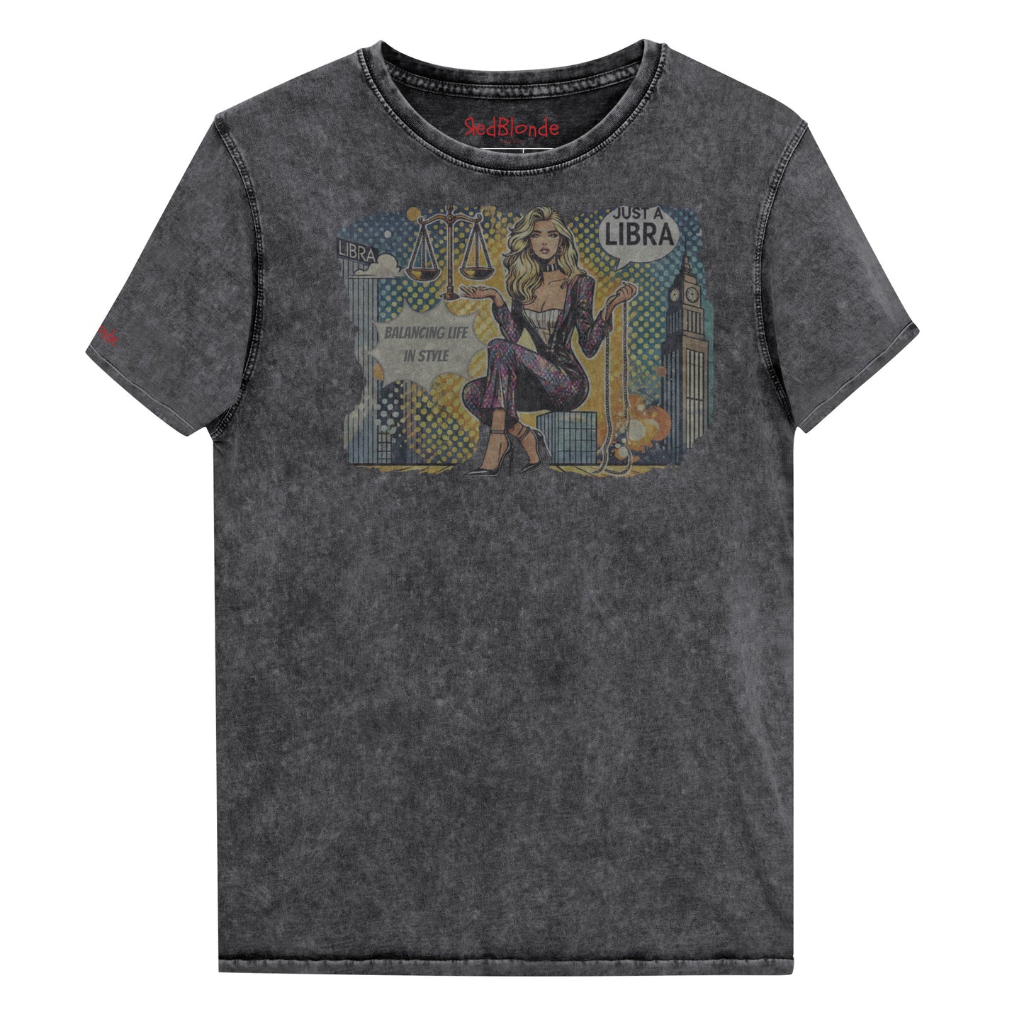 Flatlay of a unisex black denim wash vintage t-shirt with a retro pop-art Libra graphic featuring a blonde woman, scales, and a city backdrop, captioned ‘Just a Libra, Balancing Life if Style’. Branded RedBlonde on inside neck and right sleeve