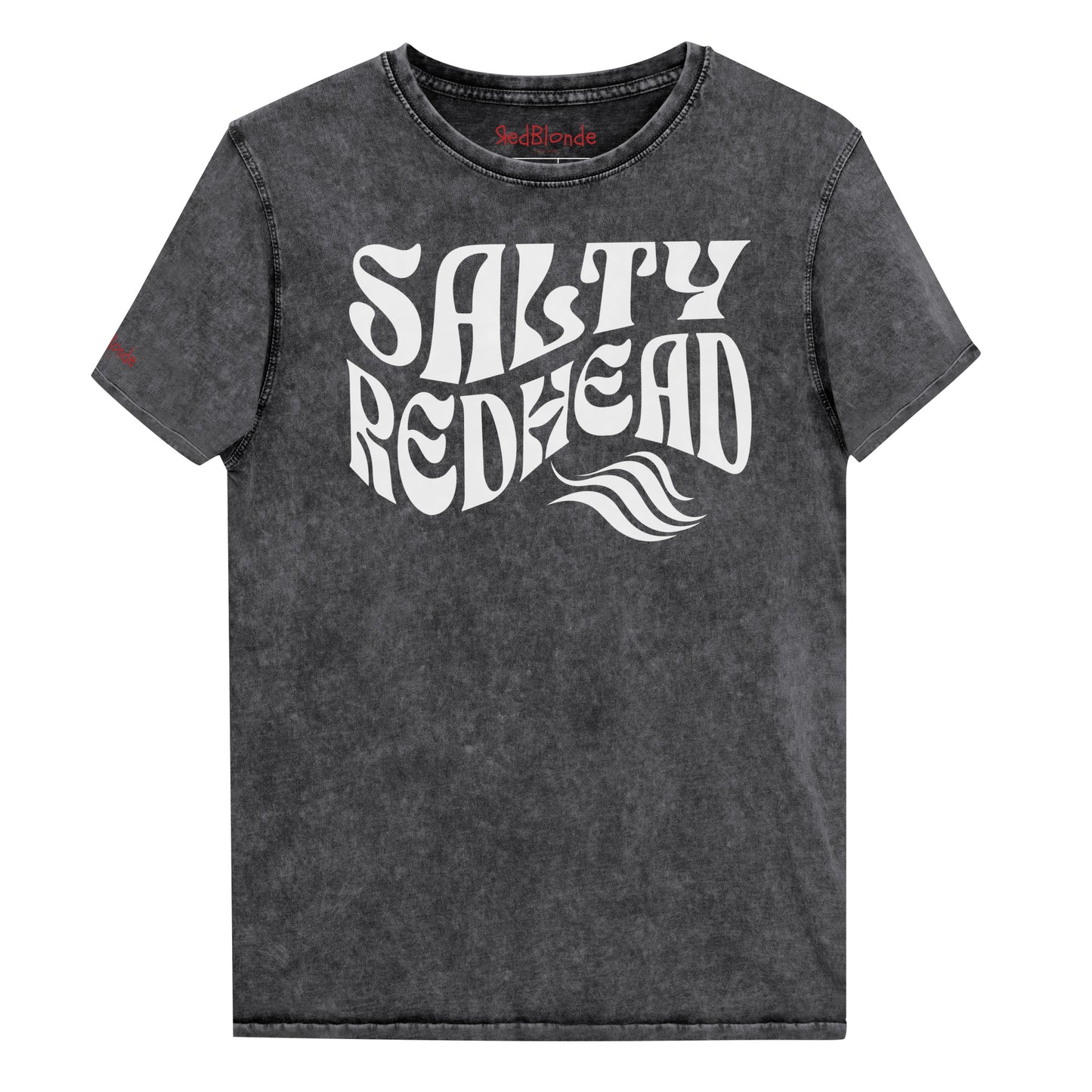 flatlay of a unisex black relaxed fit denim-wash t-shirt with the words 'Salty redhead' in retro 70s vibe text in white. Branded Redblonde on inside neck and right shoulder in red