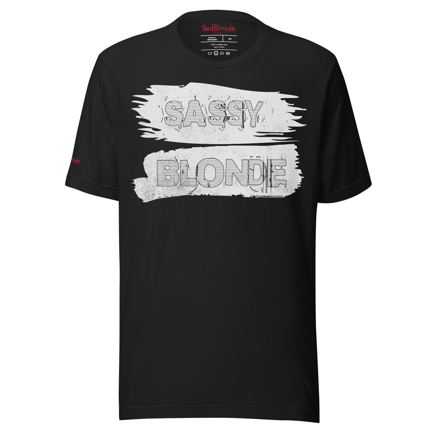 flatlay of a unisex black relaxed fit t-shirt with 'Sassy Blonde' in white black outlined text on a white paint brush stroke graphic. Branded Redblonde London in red on inside neck and right sleeve