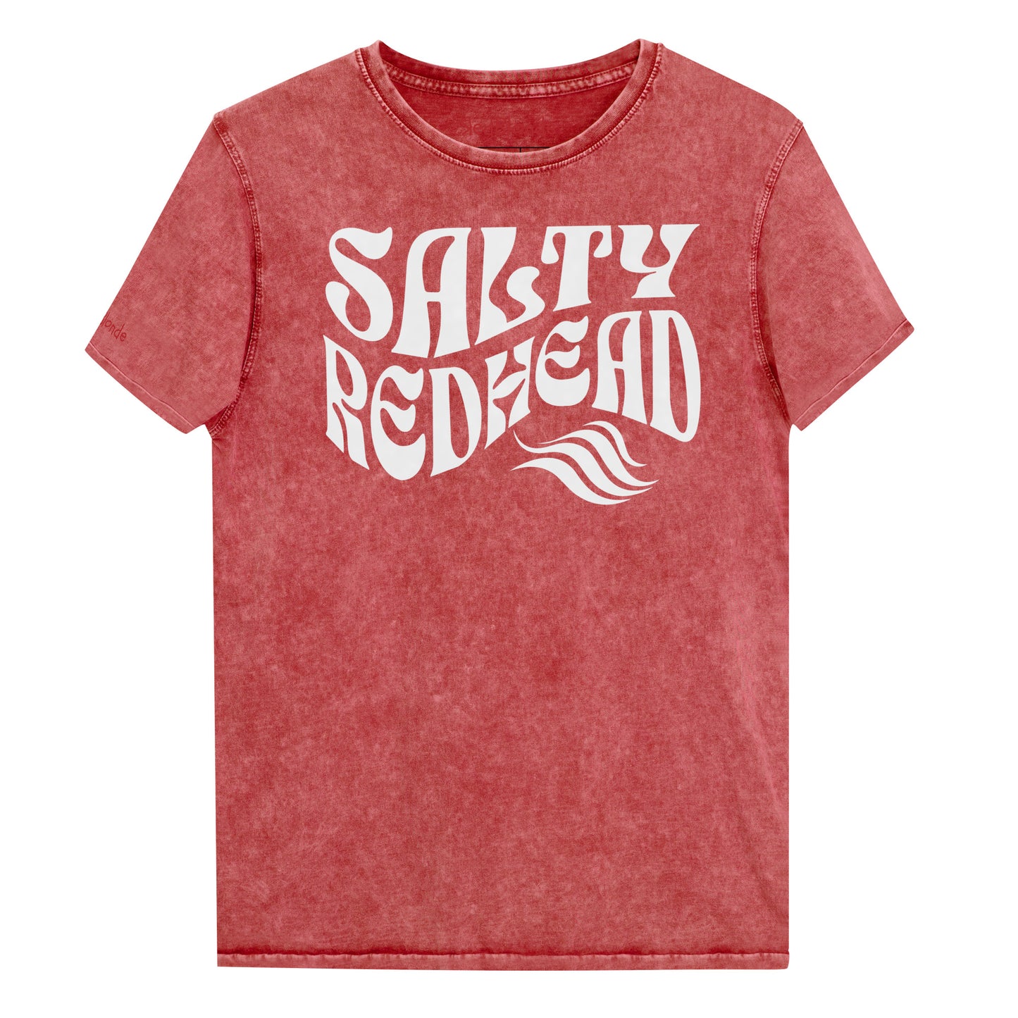 flatlay of a unisex red relaxed fit denim-wash t-shirt with the words 'Salty redhead' in retro 70s vibe text in white. Branded Redblonde on inside neck and right shoulder in red