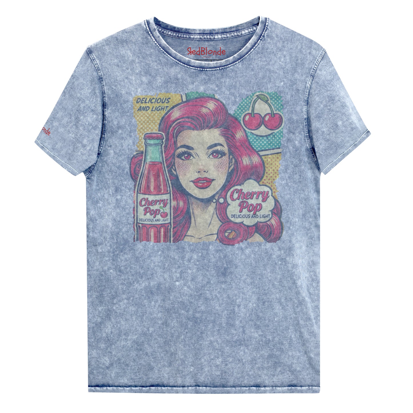 flatlay of unisex vintage blue denim wash t-shirt with a pop-art graphic of a redheaded woman with a bottle of cherry pop, cherry graphic and the words 'Cherry Pop, delicious and light' in talk bubble. Branded RedBlonde on inside neck and right sleeve in red