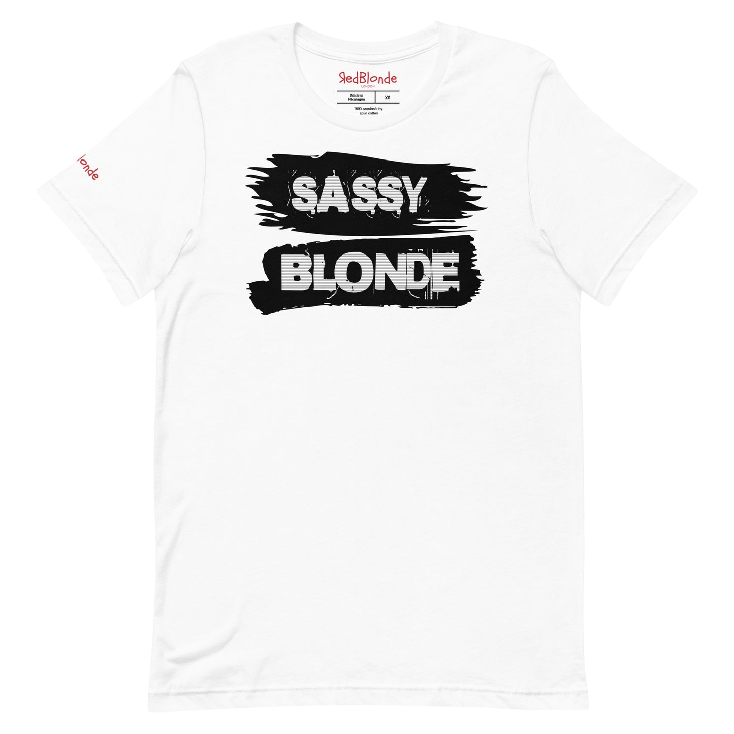 flatlay of a unisex white relaxed fit t-shirt with 'Sassy Blonde' in white black outlined text on a black paint brush stroke graphic. Branded Redblonde London in red on inside neck and right sleeve