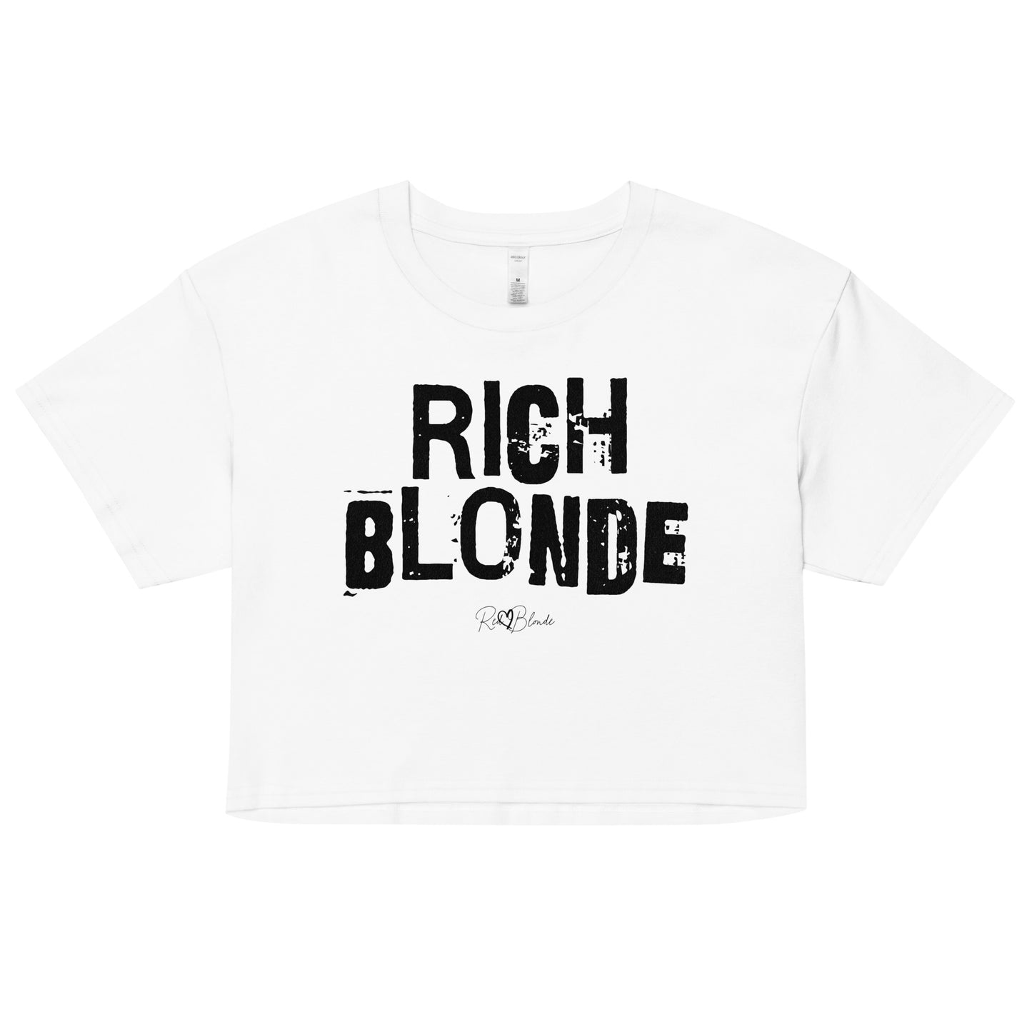 A white women’s crop top with a relaxed fit, short sleeves, and a wide crew neckline. The front features bold black distressed lettering reading “RICH BLONDE” with the RedBlonde signature logo underneath in white.