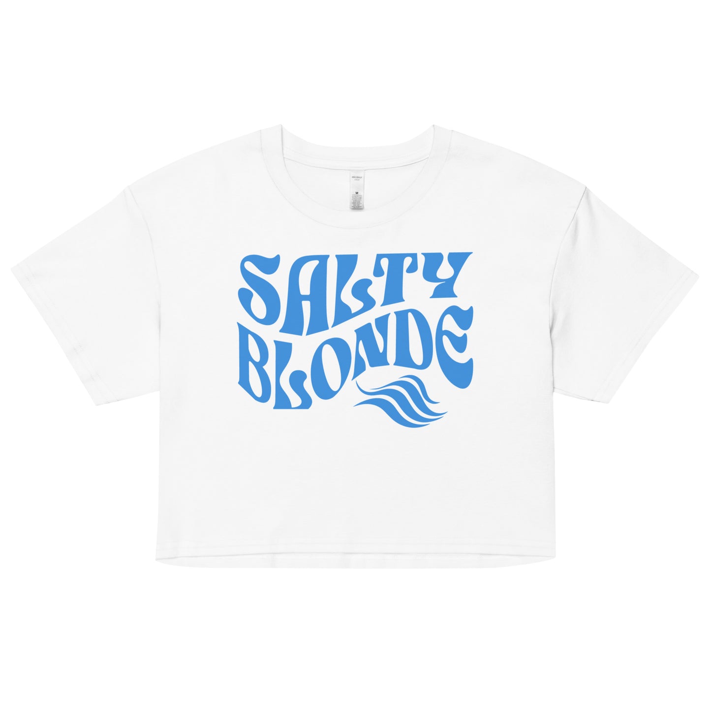 Flatlay of a white loose crop top t-shirt with the words ‘Salty Blonde’ in blue retro 70s wavy font