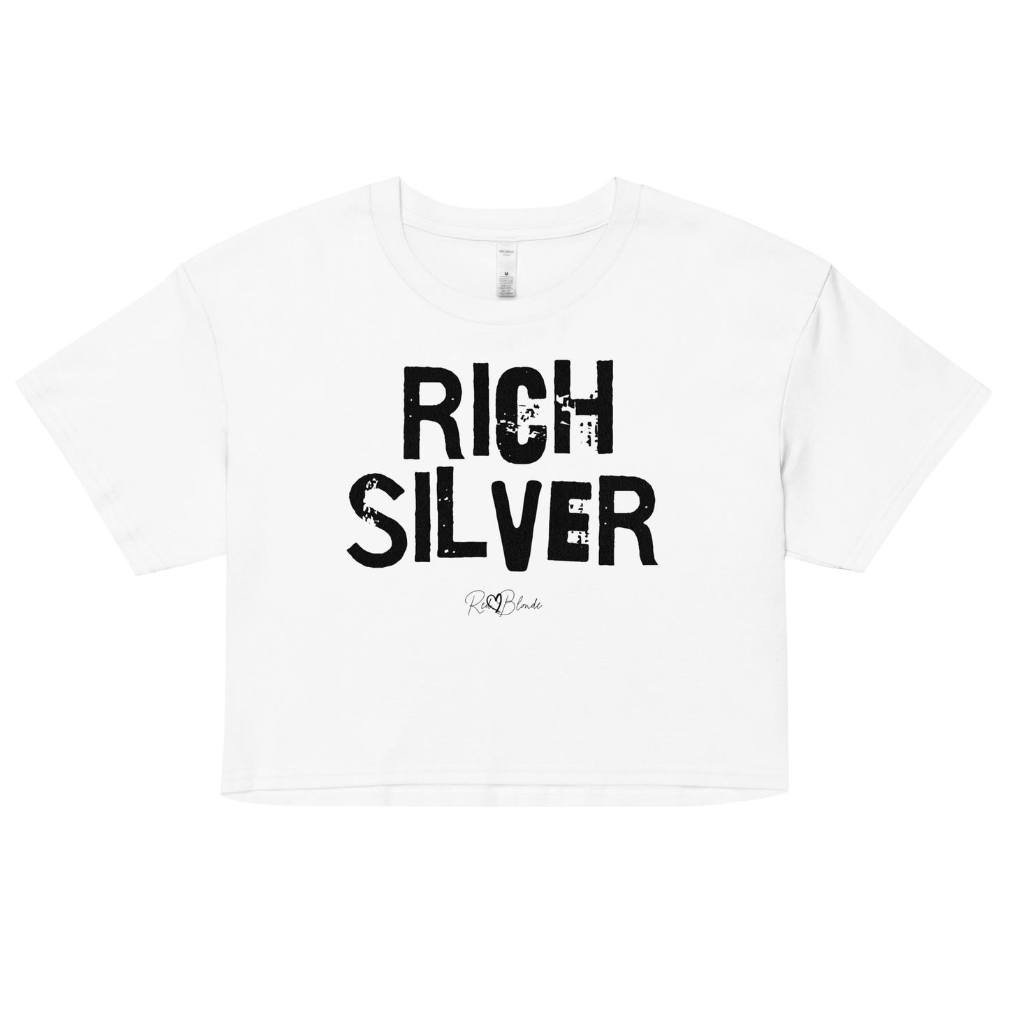 a white crop top with a relaxed fit, short sleeves, and a wide crew neckline. The front features bold black distressed lettering reading “RICH SILVER” with the RedBlonde signature logo underneath in black