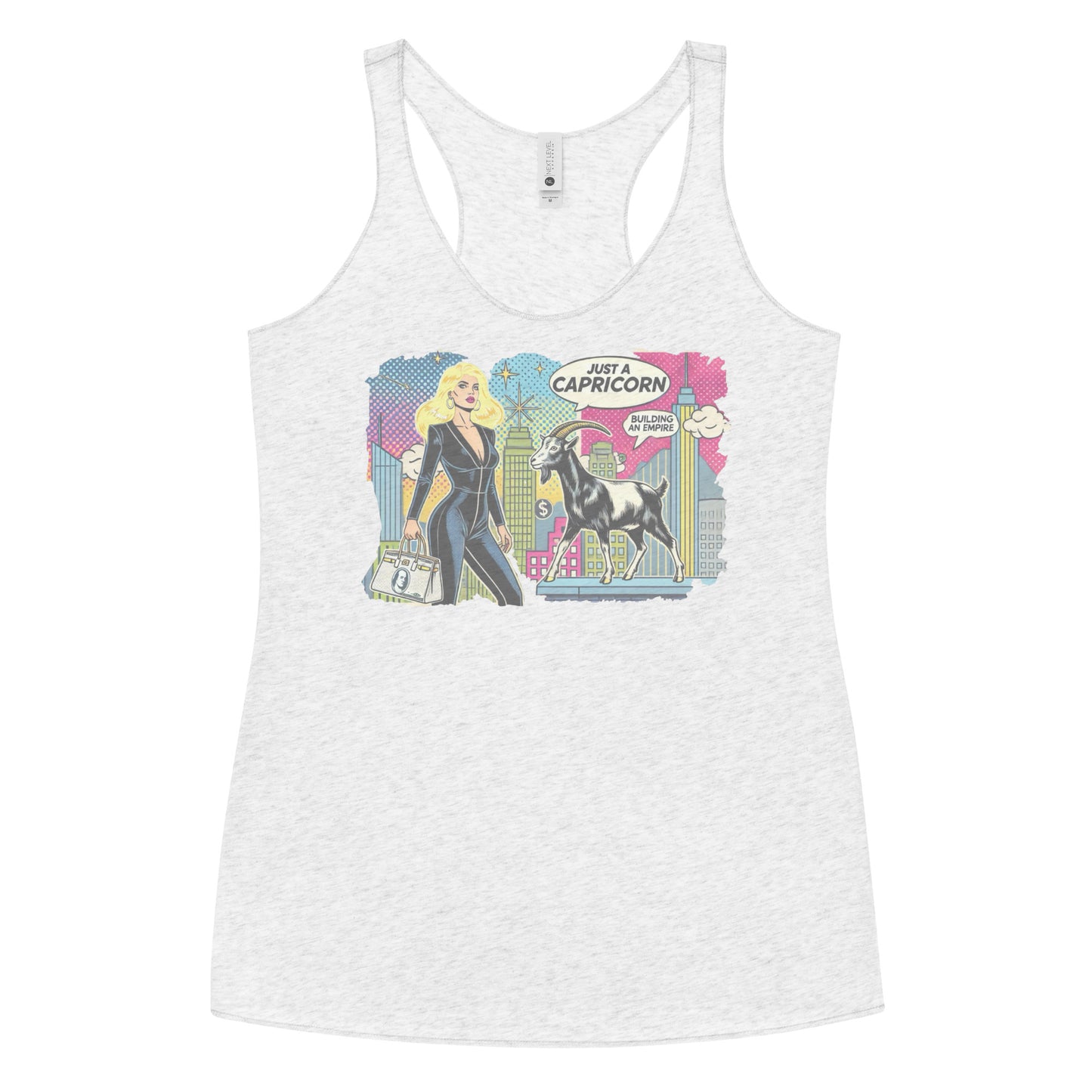 Flatlay of a heather white soft racerback tank t-shirt with a retro pop-art Blonde Capricorn graphic featuring a blonde woman in a black catsuit, carrying a bag, with a goat and a city skyscraper backdrop, captioned ‘Just a Capricorn, Building an empire'