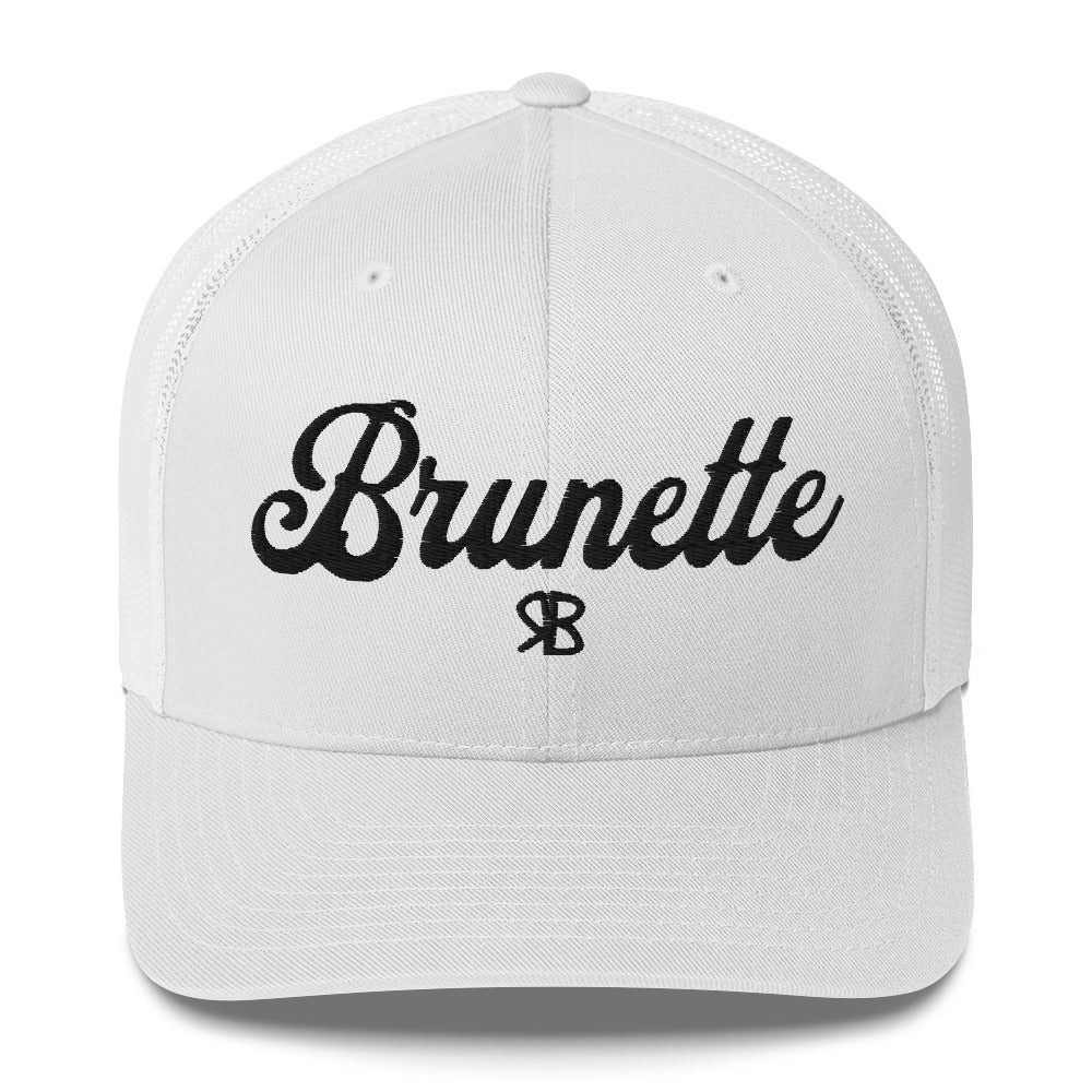 white trucker cap with 'Brunette' in black adventurer 01 font on front. Branded RB