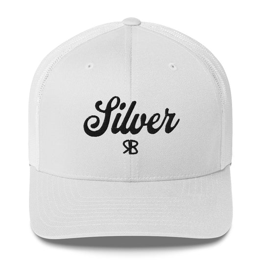 white trucker cap with 'Silver' in black adventurer 01 font on front. Mesh back. Branded RB