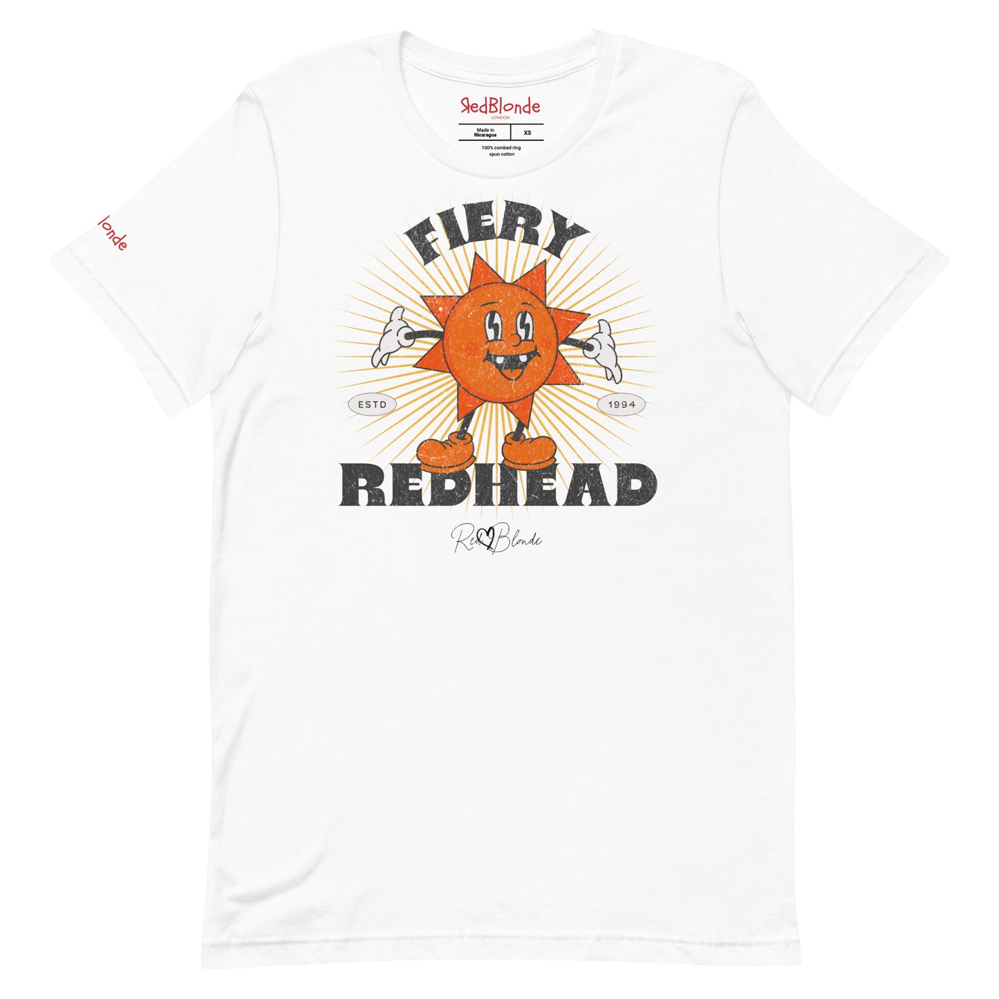 White unisex crew neck t-shirt with a bold retro graphic of a smiling orange cartoon sun character, surrounded by radiant sunbeams. The text reads ‘Fiery Redhead’ in distressed black Belzebuth lettering with small details including ‘ESTD 1994’ and the RedBlonde signature logo beneath."