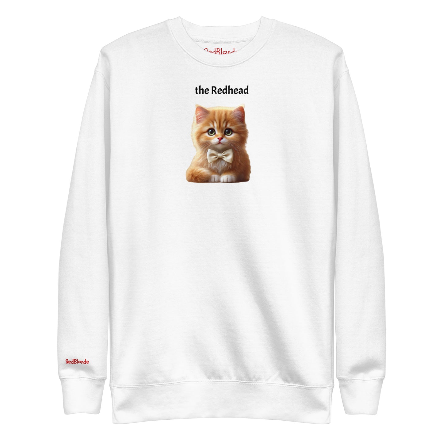 Flatlay of white relaxed fit unisex sweatshirt with a cute graphic of a redhead kitten wearing a bow-tie and the words 'the Redhead' linking to Red hair. Branded RedBlonde in red on inside neck and right cuff
