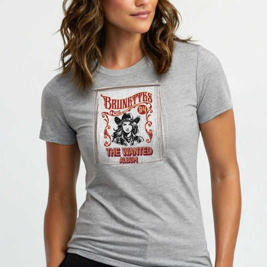 woman wears Athletic heather gray classic unisex relaxed fit t-shirt with graphic of an album cover featuring a girl in a cowboy hat with the words ' Brunettes'94 - The Wanted Album'. Branded RedBlonde in red on inside neck and right sleeve.