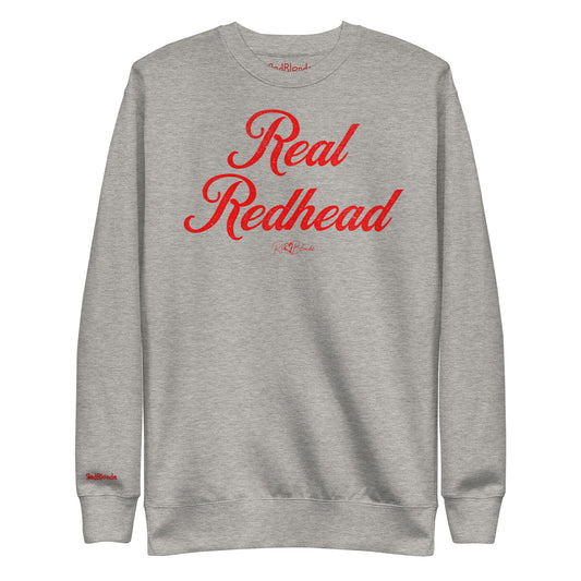 A classic grey relaxed fit unisex sweatshirt with the words 'Real Redhead' written in red vintage milkstore font, like coco cola script. Branded RedBlonde London in red on inside neck and right sleeve 