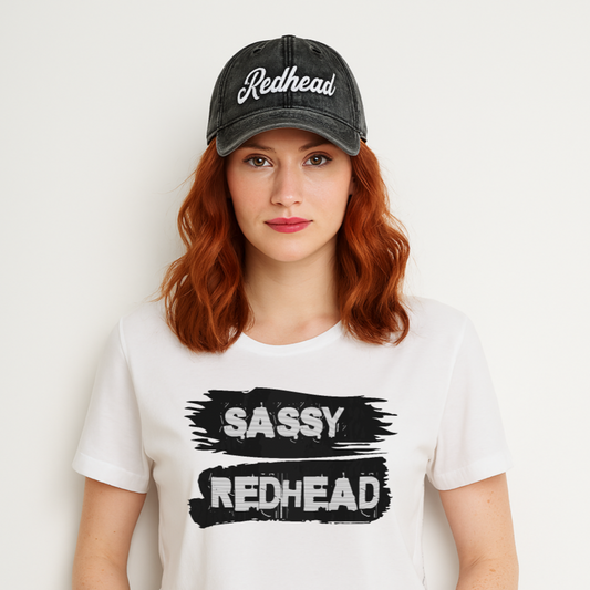 A redhead wearing a vintage black denim wash effect baseball cap with the word 'Redhead' embroidered on the front in white adventure type script font 
