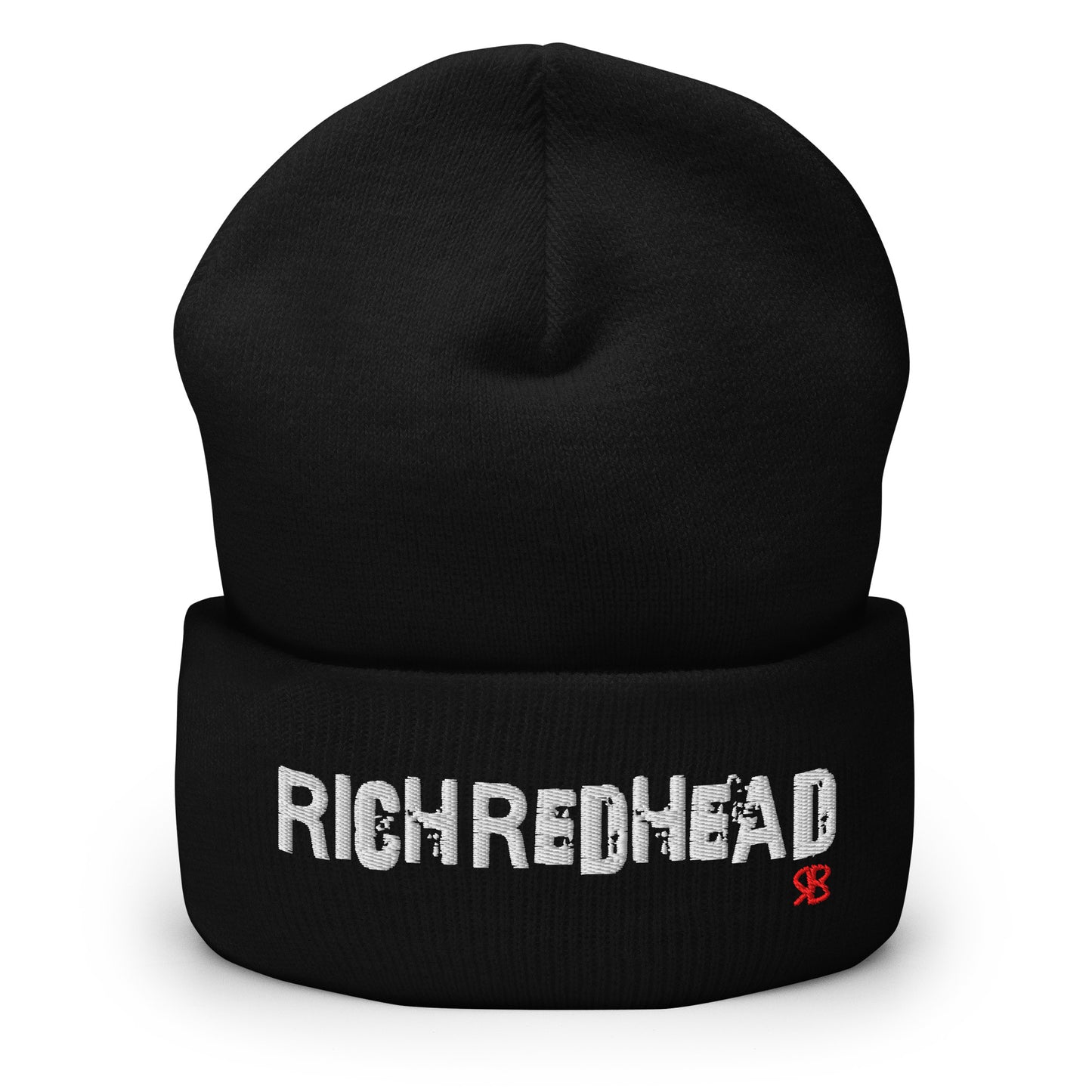 Black cuffed beanie with the embroidered slogan “RICH REDHEAD” in bold white distressed-style lettering, featuring a small red “RB” RedBlonde logo on the right side of the fold. The beanie is shown upright against a clean white background.