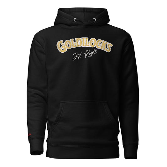 Black unisex hoodie with the text “Goldilocks Just Right” in gold and white Signmaster Pro textured font, designed in a bold retro style. Branded RedBlonde London in red on inside neck and right sleeve 