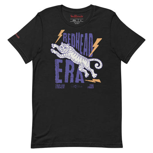 Black unisex short-sleeve t-shirt featuring a bold graphic of a leaping tiger outlined in purple, surrounded by orange lightning bolts. The text “REDHEAD ERA” appears in large distressed purple letters, with smaller text reading “TIGER-LIKE STRENGTH” and “TRUE POWER” underneath. Signed RedBlonde. The brand name “RedBlonde” is printed in red on the inside collar label and on the right sleeve near the cuff.