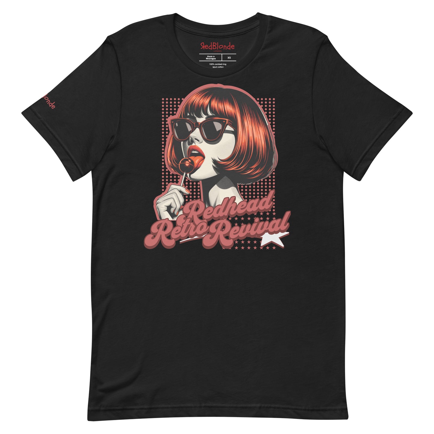 Black unisex t-shirt featuring a bold pop-art graphic of a stylish redheaded woman with a sleek bob haircut, red lips, and black sunglasses, holding a lollipop. The design includes red halftone dots and the retro-styled slogan "Redhead Retro Revival" in cursive typography with a star accent. RedBlonde branding appears on the inner neck label and red sleeve in red text.