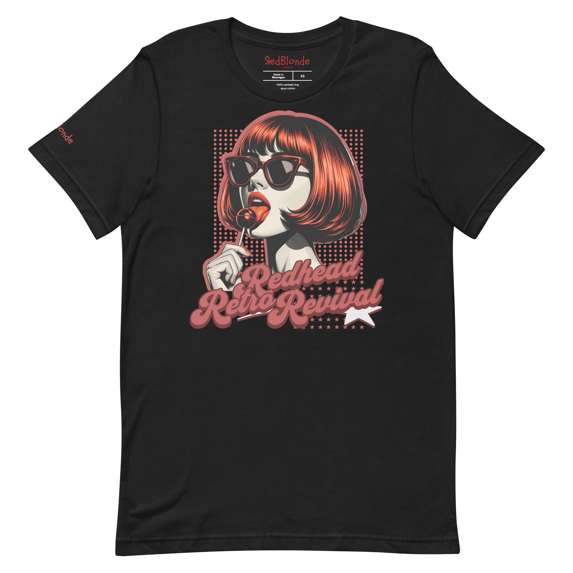 Black unisex t-shirt featuring a bold pop-art graphic of a stylish redheaded woman with a sleek bob haircut, red lips, and black sunglasses, holding a lollipop. The design includes red halftone dots and the retro-styled slogan "Redhead Retro Revival" in cursive typography with a star accent. RedBlonde branding appears on the inner neck label and red sleeve in red text.