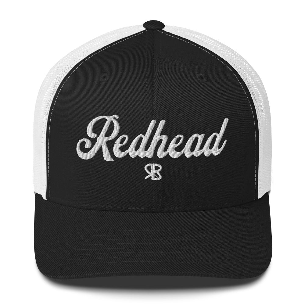 Black /white trucker cap with 'Redhead' in white  adventurer 01 font on front. Mesh back. Branded RB