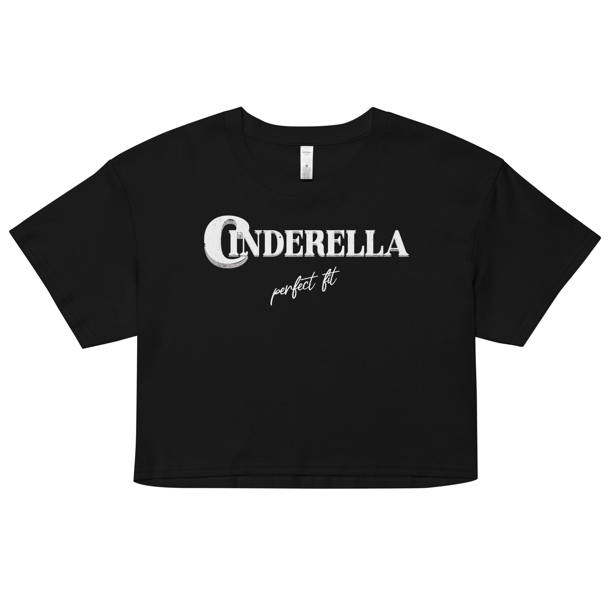 Black women’s crop top featuring white merger text that reads “Cinderella” with a decorative crescent moon incorporated into the letter C, and the phrase “perfect fit” written underneath in an elegant cursive script.