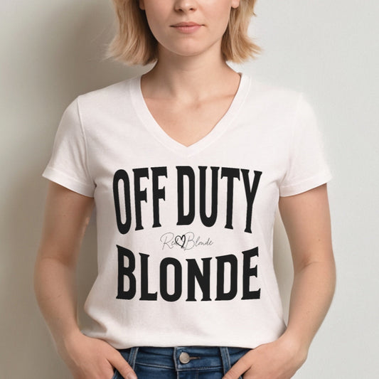 Blonde wears a classic white relaxed fit unisex v-neck t-shirt with the words 'OFF DUTY BLONDE' written in large Brookfield black font, across the front. Branded RedBlonde London in red on inside neck and right sleeve