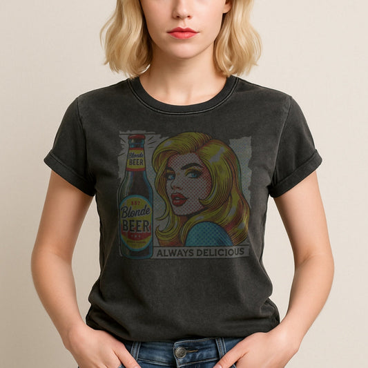 Blonde wears of a unisex vintage black denim wash t-shirt featuring a pop-art graphic of the head and shoulders of a Blonde woman next to a bottle of Beer, labelled Blonde Beer, Always Delicious. branded RedBlonde in red on inside neck and right sleeve 