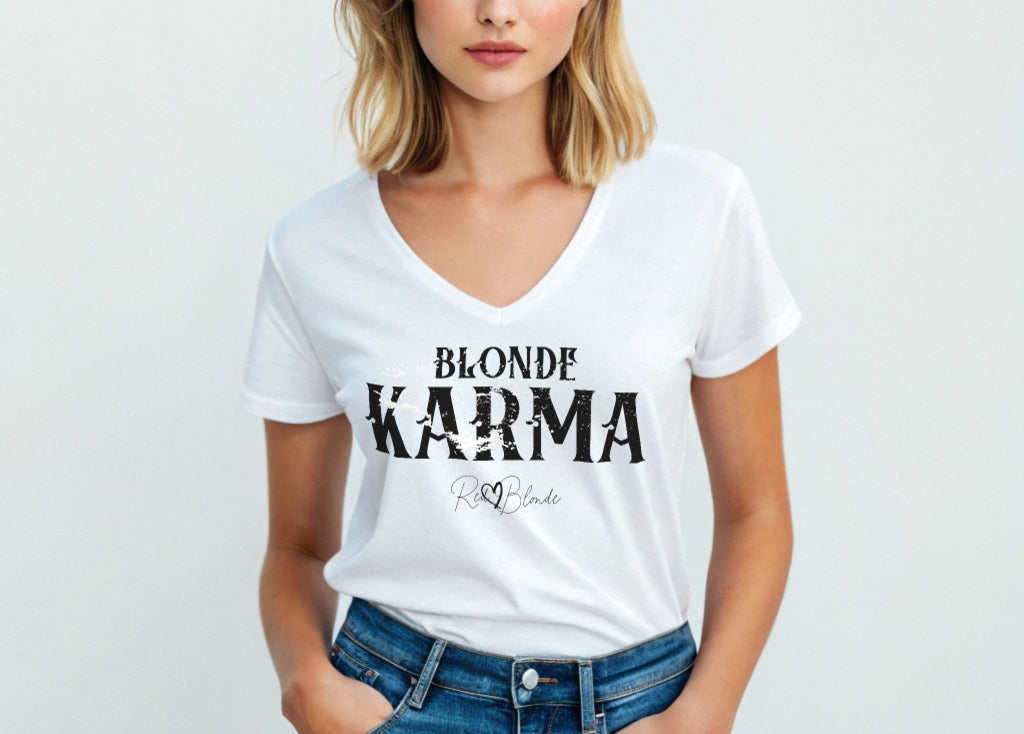 Blonde woman wears a white v-neck women's relaxed fit t-shirt with 'BLONDE KARMA' in Aquero black font, signed RedBlonde. Branded RedBlonde in red on inside neck and right sleeve 