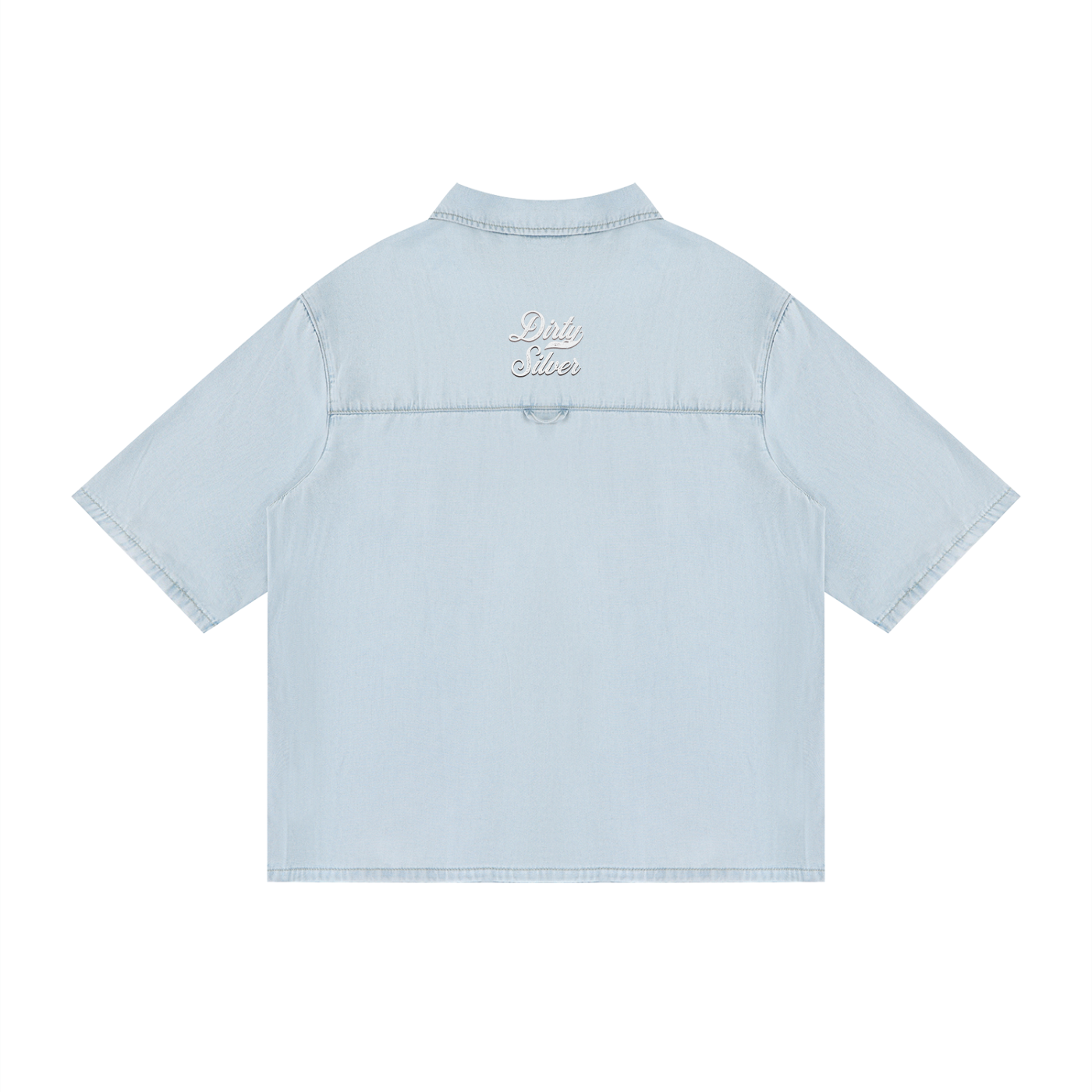 Back view of a light-wash, short-sleeve button-up shirt with a subtle faded finish and a small raised “Dirty Silver” Milkstore script logo centered across the upper back.