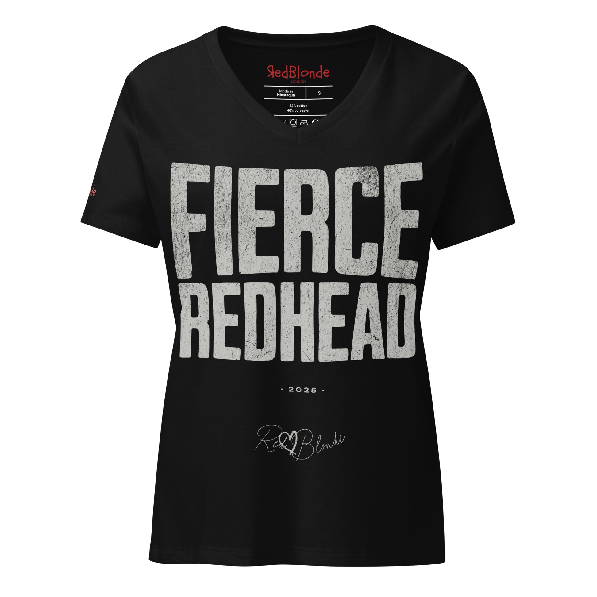 black women’s V-neck T-shirt featuring the bold black distressed text “FIERCE REDHEAD” in large North Road capital letters across the chest. Beneath the text, the year “2025” is printed in small type, with the “RedBlonde” brand signature logo below it. The inner collar shows the “RedBlonde” brand name in red along with sizing and care details, and “RedBlonde” is also printed in small red letters on the right sleeve.