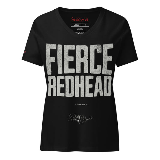 black women’s V-neck T-shirt featuring the bold black distressed text “FIERCE REDHEAD” in large North Road capital letters across the chest. Beneath the text, the year “2025” is printed in small type, with the “RedBlonde” brand signature logo below it. The inner collar shows the “RedBlonde” brand name in red along with sizing and care details, and “RedBlonde” is also printed in small red letters on the right sleeve.
