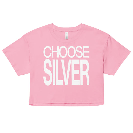 Flatlay of a pink women's crop top  graphic t-shirt with “CHOOSE SILVER” in white Helvetica Now font emblazoned on the front. 