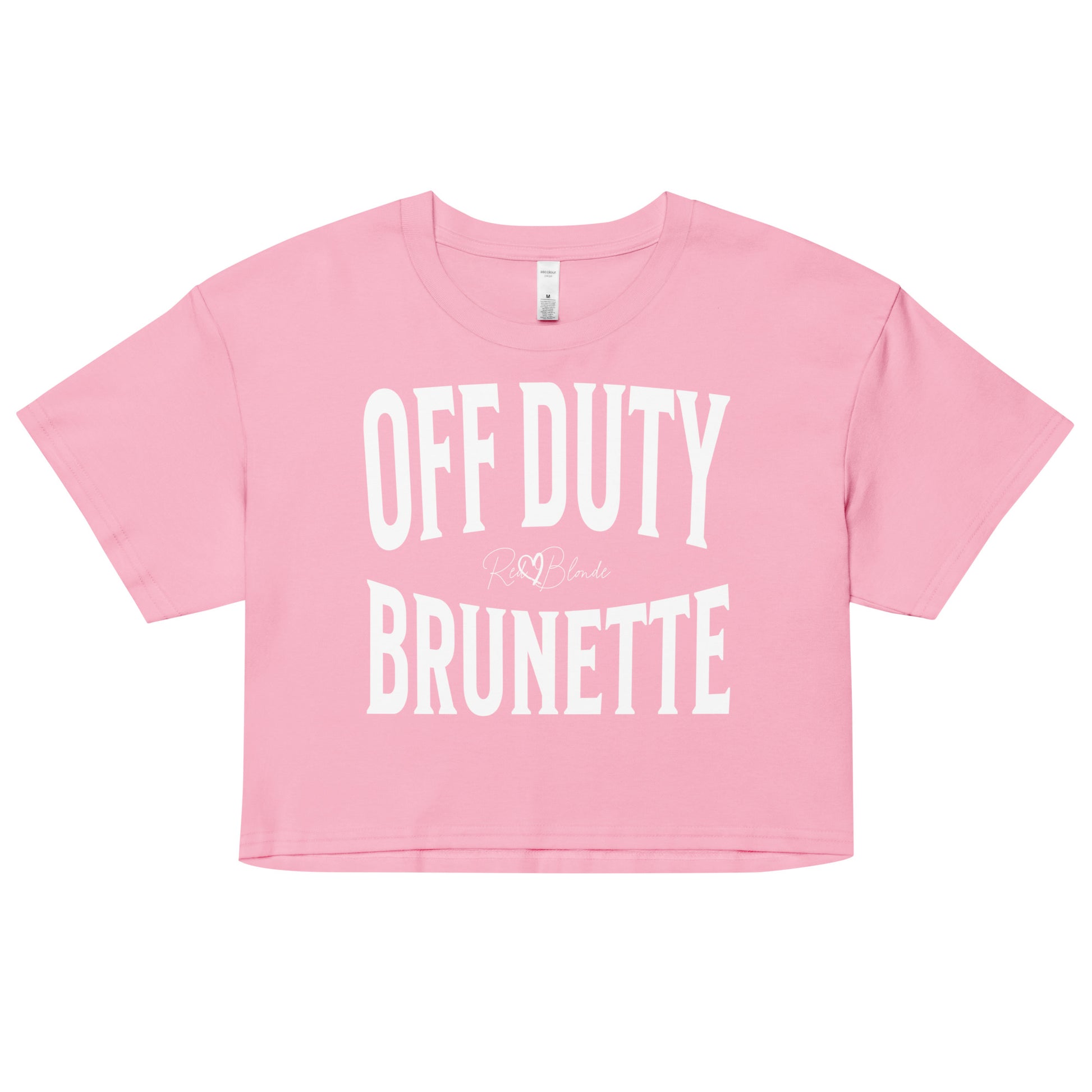Flatlay of a pink women's crop top  graphic t-shirt with “OFF DUTY BRUNETTE” in white Helvetica Now font emblazoned on the front, signed off RedBlonde