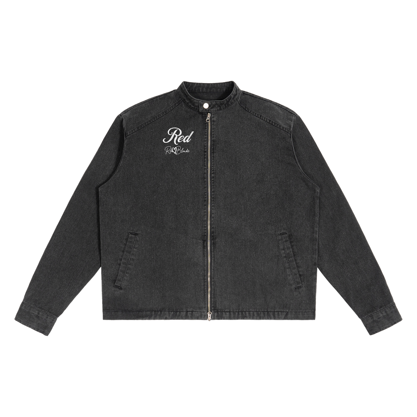 A washed-black denim jacket with a straight, boxy cut and a stand collar. The front features a full silver zip, two slanted pockets, and white embroidered text on the left chest that reads "Red" with the RedBlonde signature underneath. The jacket has long sleeves with button cuffs
