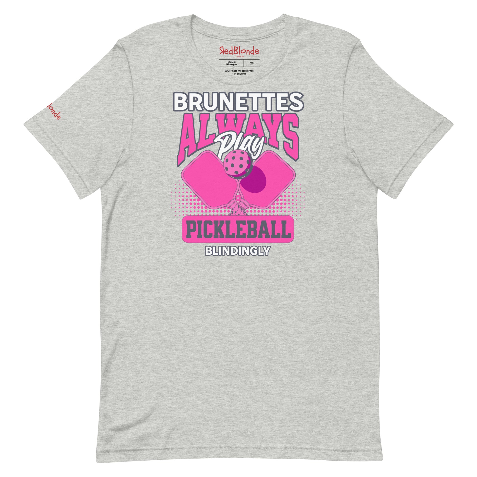 Grey unisex t-shirt with bold pink and white graphic that says "Brunettes Always Play Pickleball Blindingly," featuring two pink pickleball paddles and a ball. Branded RedBlonde on inside neck and right sleeve