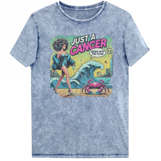 Flatlay of a unisex blue denim wash vintage t-shirt with a retro pop-art Cancer graphic featuring a dark-haired woman, wearing a turquoise short strapless catsuit, fur coat and strappy heels, walking a pink crab on a leash, with a high water wave and city backdrop captioned Just an Caner, Going with the Flow'. Branded RedBlonde on inside neck and right sleeve 