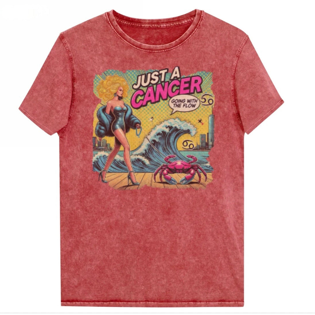 Flatlay of a unisex red garnet denim wash vintage t-shirt with a retro pop-art Cancer graphic featuring a blonde woman, wearing a turquoise short strapless catsuit, fur coat and strappy heels, walking a pink crab on a leash, with a high water wave and city backdrop captioned Just an Caner, Going with the Flow'. Branded RedBlonde in red on inside neck and right sleeve 