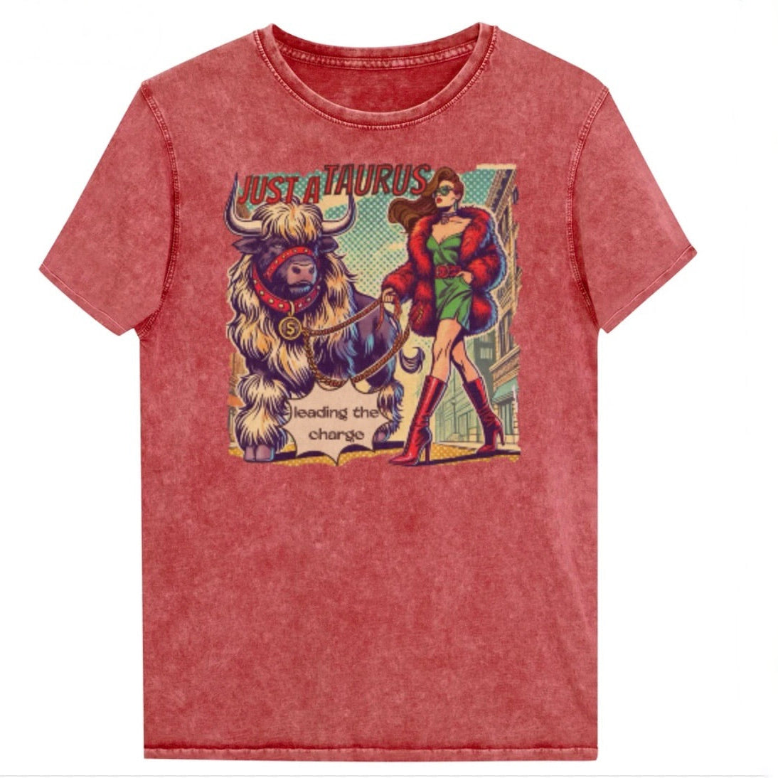 Flatlay of a unisex relaxed fit red garnet vintage denim wash t-shirt with a retro pop-art taurus graphic featuring a brunette woman with long flowing straight hair, wearing a green dress with a red belt, red high-heeled boots and red fur coat, walking a furry bull with a red collar and medallion in city street captioned ‘Just a taurus leading the charge'. Branded RedBlonde on inside neck and right shoulder