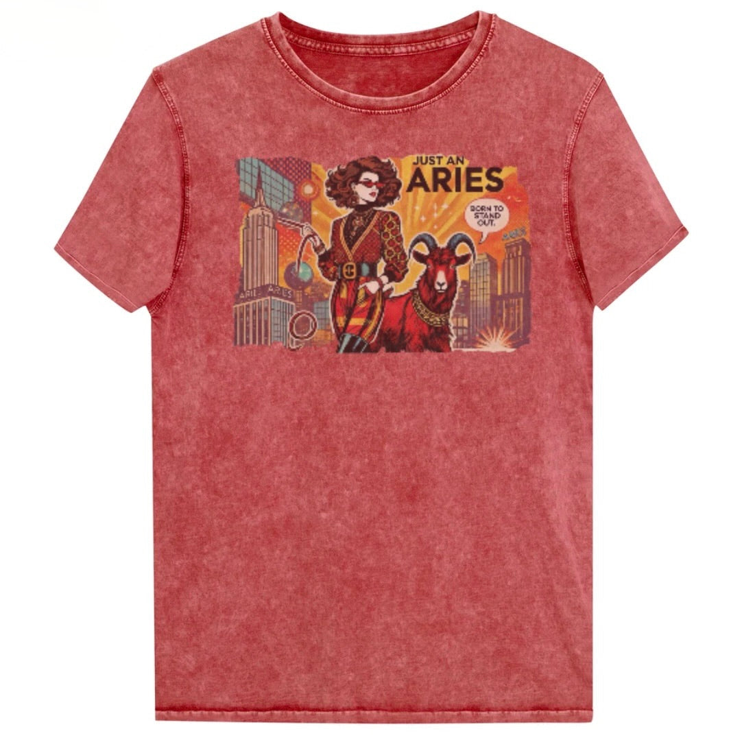 Flatlay of a unisex red garnet denim wash vintage t-shirt with a retro pop-art brunette Aries graphic featuring a Brunette woman, wearing a belted catsuit and high boots with one hand in her pocket, with a ram by her side and a city backdrop, captioned ‘Just an Aries, born to stand out'. Branded RedBlonde in red on inside neck and right sleeve