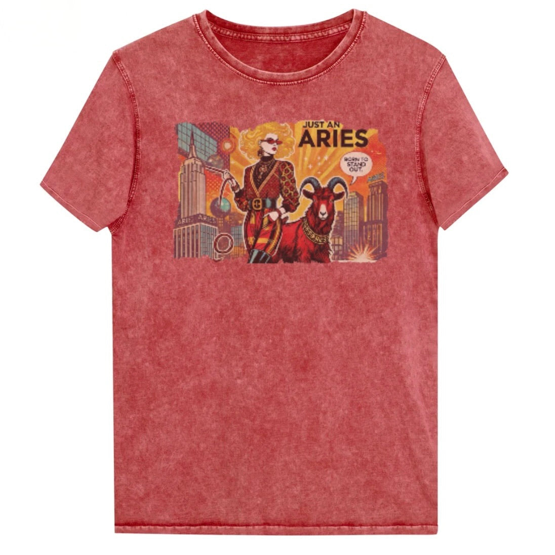 Flatlay of a unisex garnet red denim wash vintage t-shirt with a retro pop-art Aries graphic featuring a blonde woman, wearing a belted catsuit and high boots with one hand in her pocket, with a ram by her side and a city backdrop, captioned ‘Just an Aries, born to stand out'. Branded RedBlonde on inside neck and right sleeve