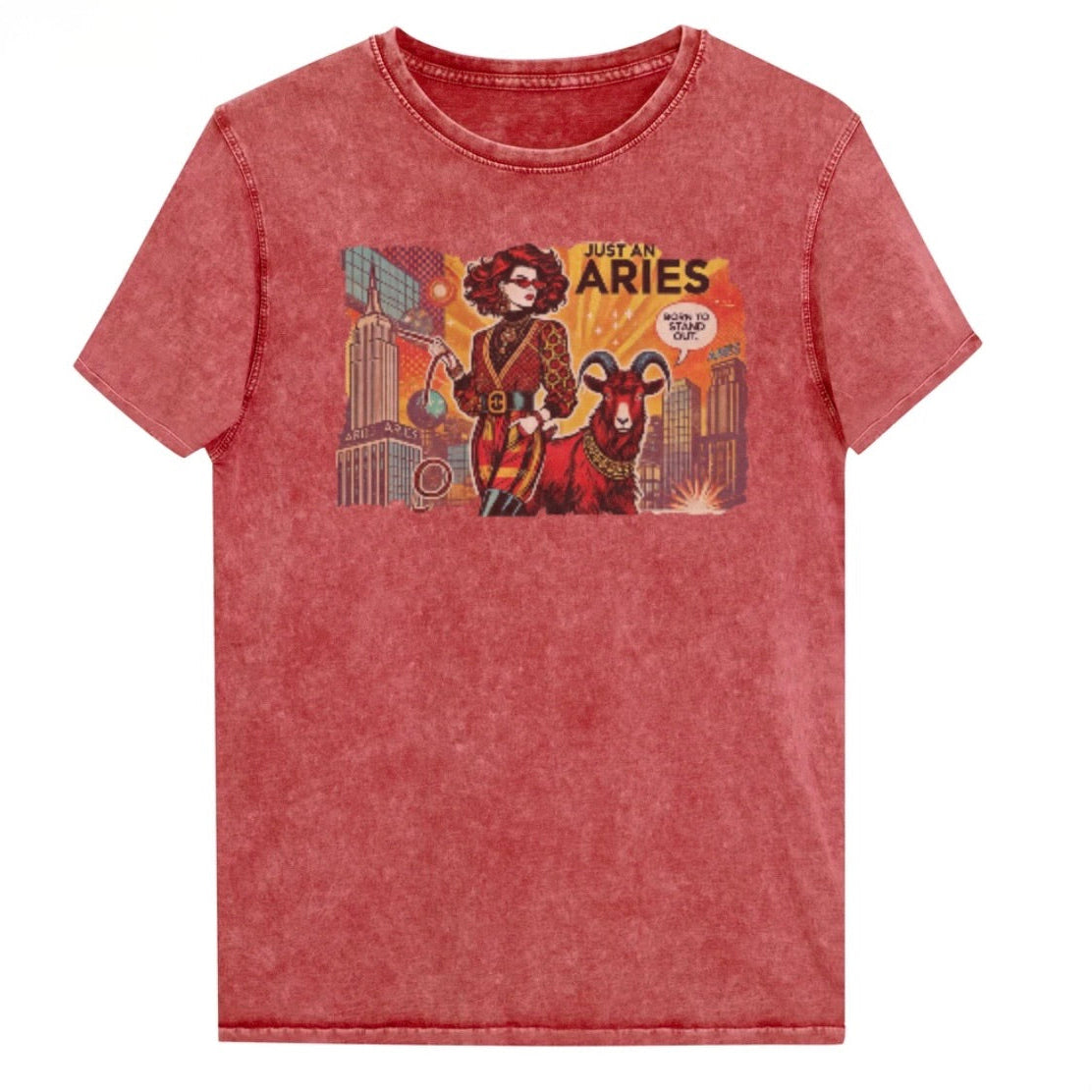 Flatlay of a unisex garnet red denim wash vintage t-shirt with a retro pop-art Aries graphic featuring a redhead woman, wearing a belted catsuit and high boots with one hand in her pocket, with a ram by her side and a city backdrop, captioned ‘Just an Aries, born to stand out'. Branded RedBlonde on inside neck and right sleeve