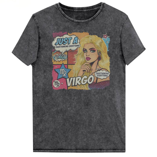 Flatlay of a unisex black denim wash vintage t-shirt with a retro pop-art Virgo graphic featuring the head and shoulders of a blonde woman, wearing an off the shoulder top with her hand on her chin, the background is colourful chequered board with two bubble  captions ‘Just an Virgo, overthinking everything'. Branded RedBlonde in red on inside neck and right sleeve