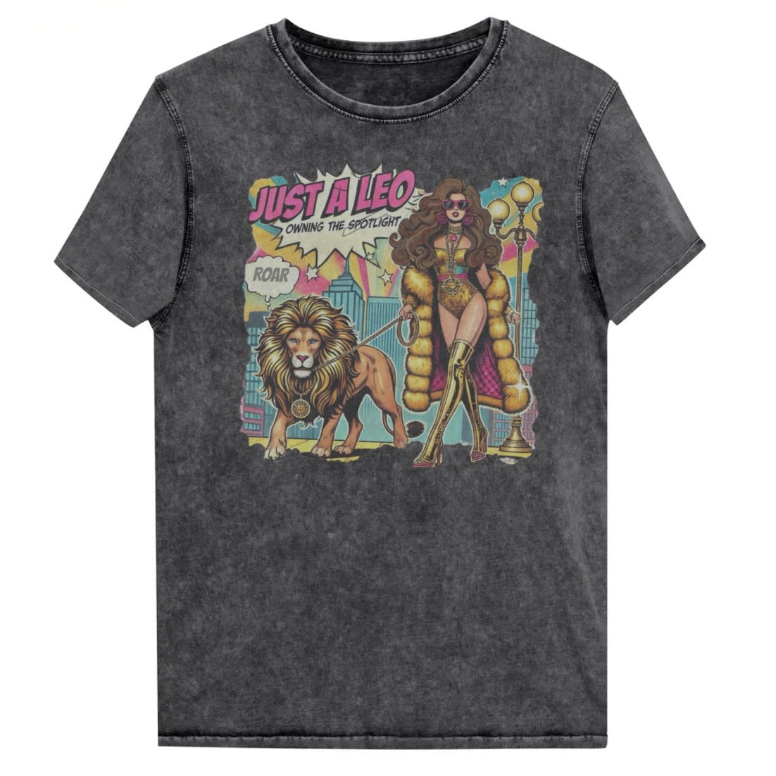Flatlay of a unisex black denim wash vintage t-shirt with a retro pop-art Brunette Leo graphic featuring a long haired brunette woman in a gold swimsuit, gold over the knee boots, gold medallion and long fur coat, walking a lion on a leash wearing a gold medallion, with a caption bubble 'Roar', with a city and round bulb street lights in the background captioned ‘Just a Leo, Owning the Spotlight'. Branded RedBlonde in red on inside neck and right shoulder