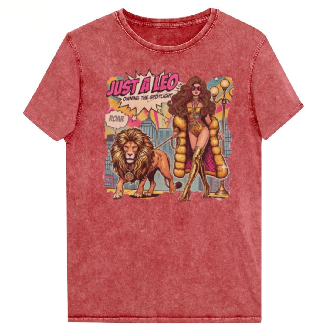 Flatlay of a unisex red garnet wash vintage t-shirt with a retro pop-art Brunette Leo graphic featuring a long haired brunette woman in a gold swimsuit, gold over the knee boots, gold medallion and long fur coat, walking a lion on a leash wearing a gold medallion, with a caption bubble 'Roar', with a city and round bulb street lights in the background captioned ‘Just a Leo, Owning the Spotlight'. Branded RedBlonde in red on inside neck and right shoulder
